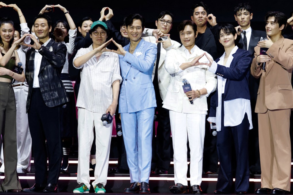 Actors from “Squid Game” and director Hwang Dong-hyuk pose for photos during a fan event in Seoul on Saturday to celebrate the release of the final season of the hit series. Photo: Reuters