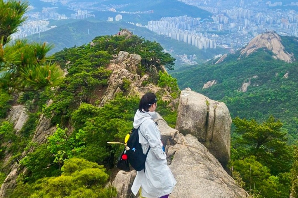 A post on the Korea Tourism Organisation’s Visit Korea Instagram account shows a hiker enjoying a view of Seoul from one of its urban mountains. Photo: Instagram/visitkorea_travel