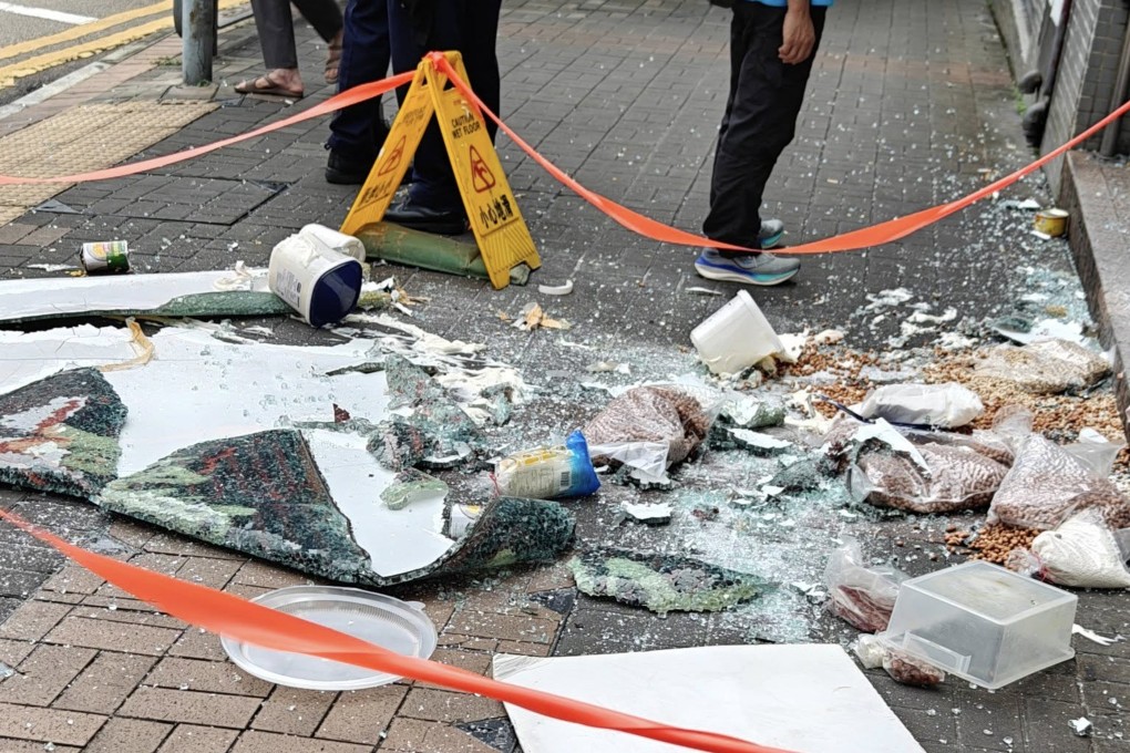 Shattered glass and food items fell onto the street from the first-floor Cafe de Coral branch. Photo: SCMP
