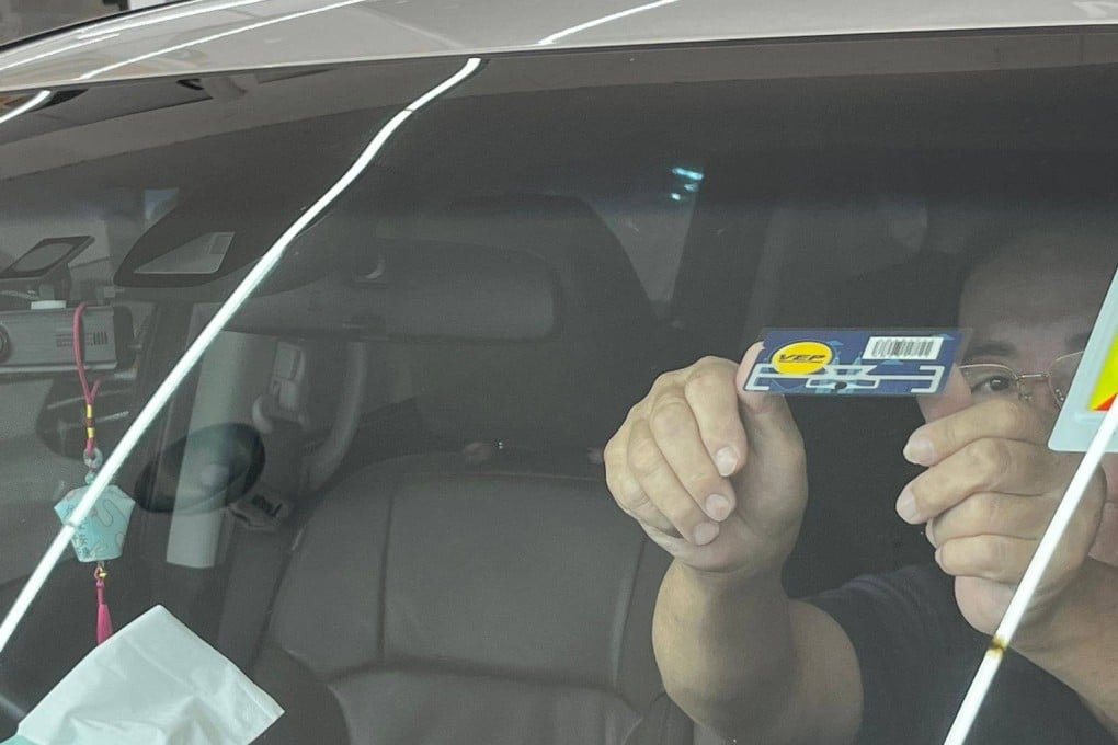 A motorist in Singapore displays his Vehicle Entry Permit as Malaysia began enforcement of the VEP scheme across the Causeway. Photo: Jean Iau