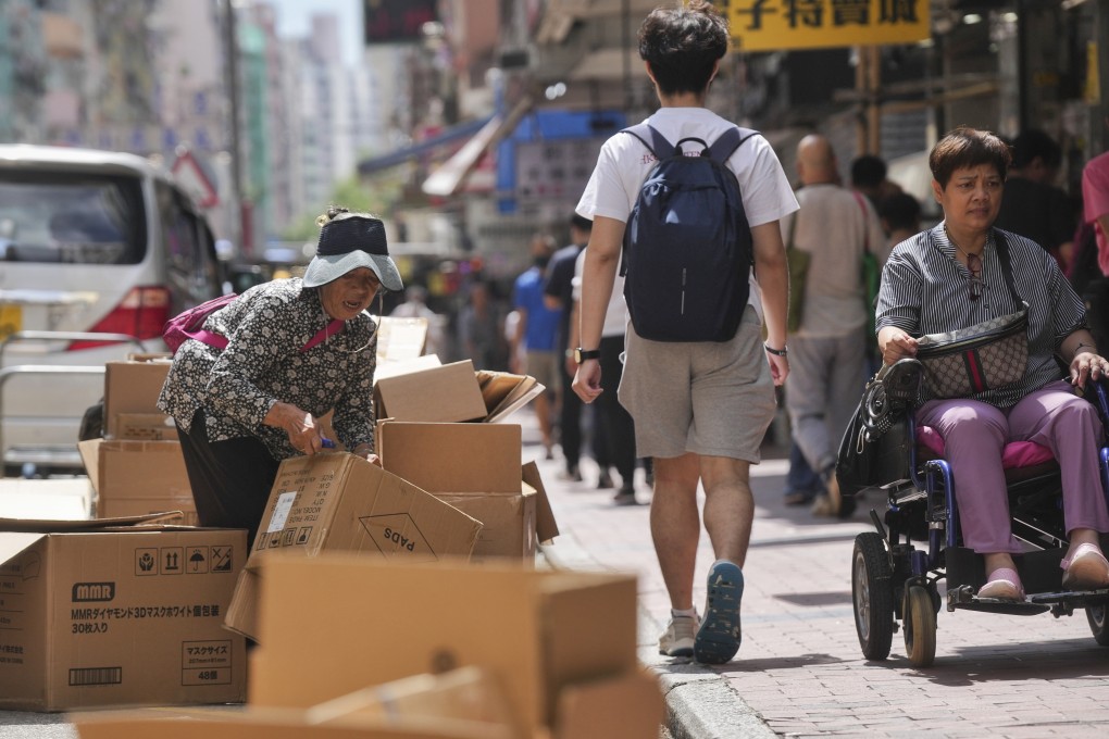 A woman sorts out cardboard on a street in Sham Shui Po on September 19, 2023. Photo: Elson Li