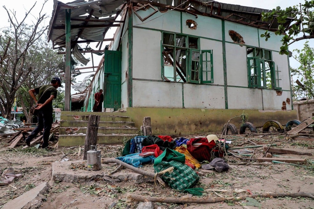 People check out a school building damaged in a bombardment carried out by Myanmar’s military in Tabayin township, Sagaing region, on May 12. Photo: AFP