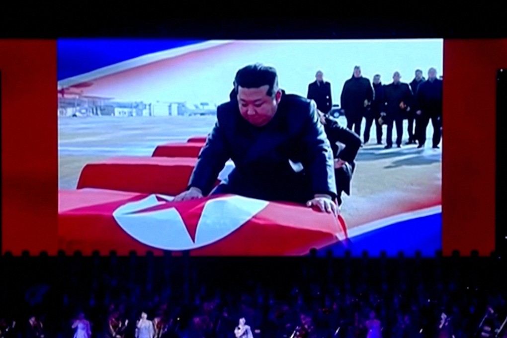 Footage showing North Korean leader Kim Jong-un draping coffins with the North Korean flag is displayed on a screen in Pyongyang during a cultural performance on Sunday. Photo: Korean Central Television / Reuters