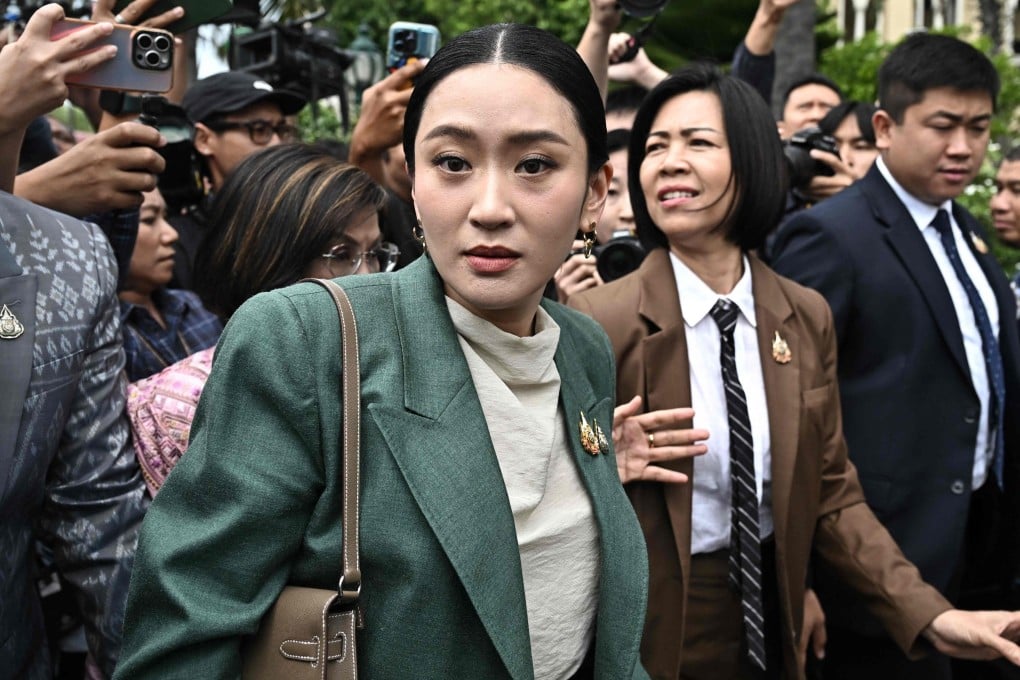 Thai Prime Minister Paetongtarn Shinawatra is swarmed by reporters on Tuesday after a cabinet meeting at Government House in Bangkok. Photo: AFP