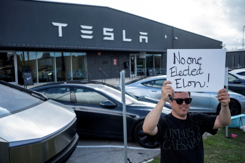 A protester outside a Tesla service centre in Austin, Texas. Photo: Reuters