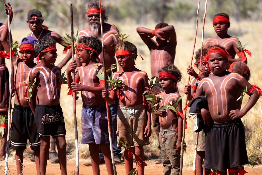Indigenous men and children prepare for a dance event in Australia’s Central Western Desert Indigenous Protected Area earlier this year. Photo: AFP