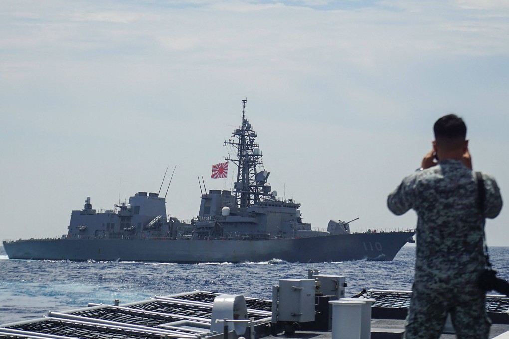 A member of the Philippine Navy looks out at the Japanese destroyer Takanami during a joint maritime exercise in the South China Sea on June 14. Photo: Jiji Press/AFP