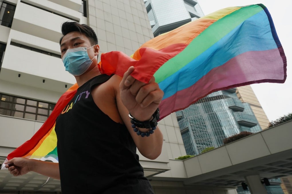 Same-sex rights activist Jimmy Sham poses with a rainbow flag at the High Court in 2020. Photo: Felix Wong
