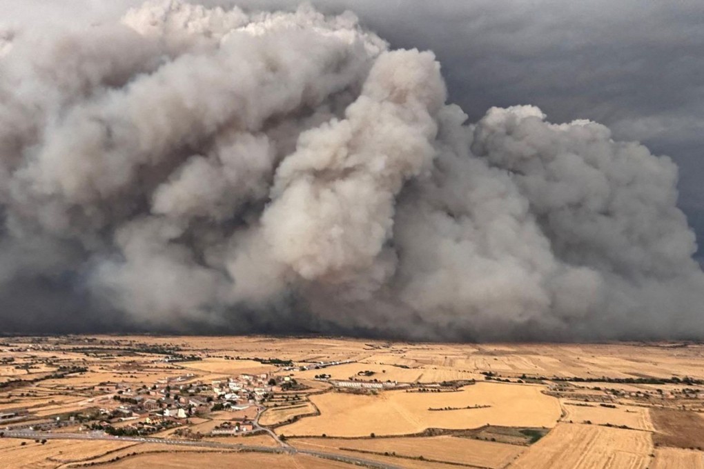 Smoke rises from a wildfire over the fields of Torrefeta i Florejacs vile, near Lleida, Spain, on Tuesday. Photo: Agents Rurals press service via Reuters