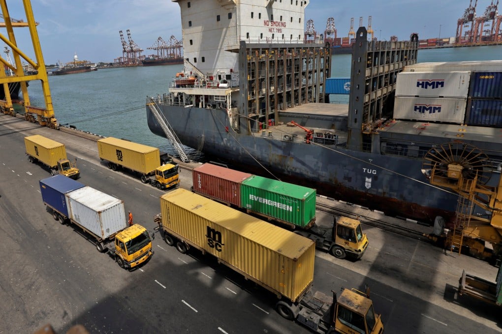 Trucks drive past shipping containers at the main port in Colombo, Sri Lanka. Colombo Dockyard is located within the port. Photo: Reuters