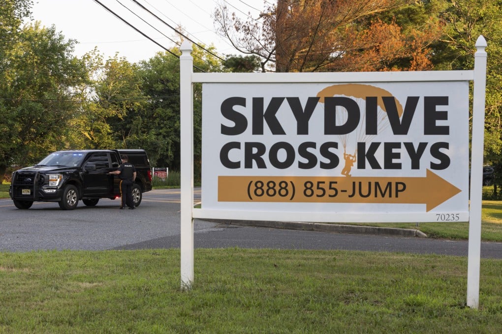 New Jersey state police direct traffic near Cross Keys Airport in Gloucester County after a skydiving aircraft went off the end of a runway and crashed into the woods on Wednesday. Photo: via AP