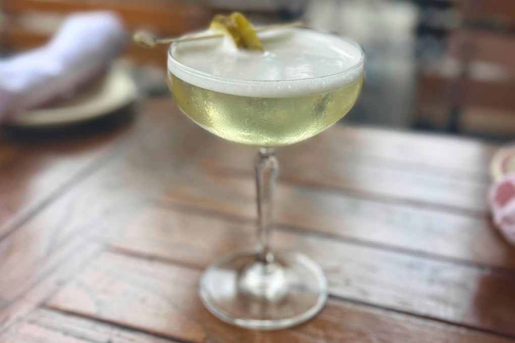 A dirty pickle martini, made with vodka, spicy pickle brine and a pickle garnish at The Penrose bar in New York. Photo: AP