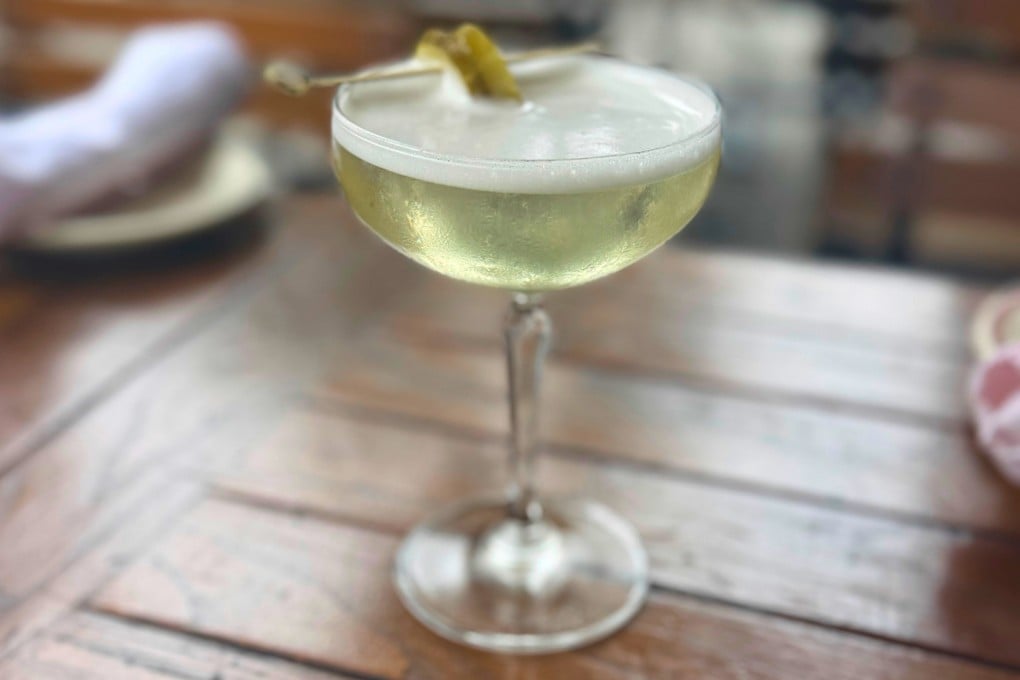 A dirty pickle martini, made with vodka, spicy pickle brine and a pickle garnish at The Penrose bar in New York. Photo: AP
