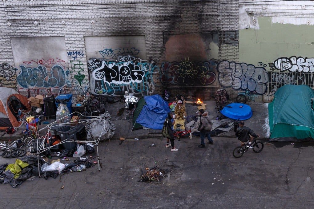 People gather in a homeless encampment in the heart of Skid Row in Los Angeles on January 10, 2024. Photo: TNS