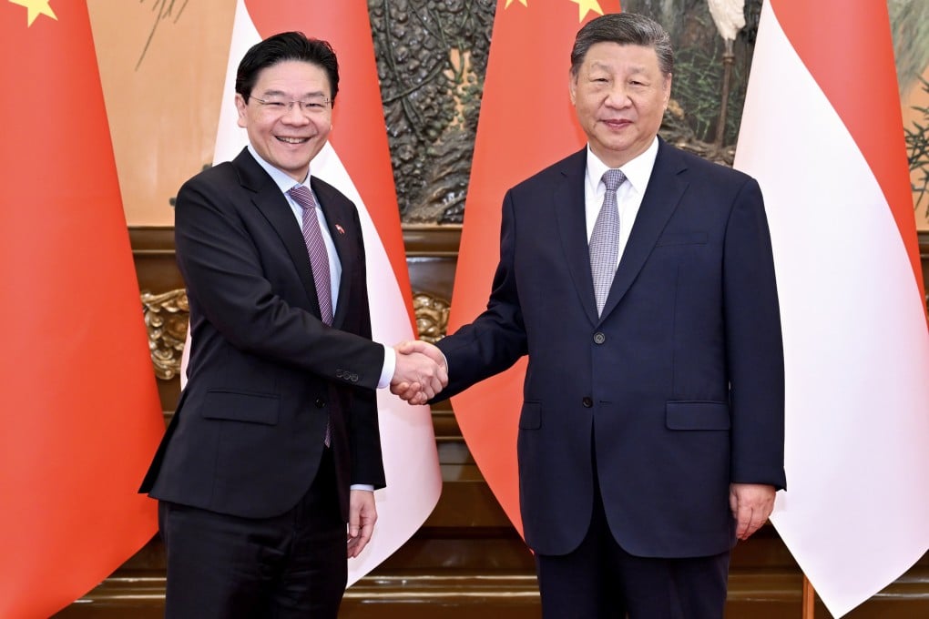 Chinese President Xi Jinping (right) greets Singaporean Prime Minister Lawrence Wong at the Great Hall of the People in Beijing on June 24. Photo: Xinhua