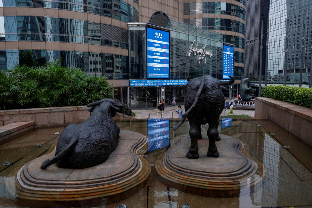 Bull statues are placed in font of screens showing the Hang Seng Index and stock prices outside Exchange Square in Hong Kong in August 2023. Photo: Reuters