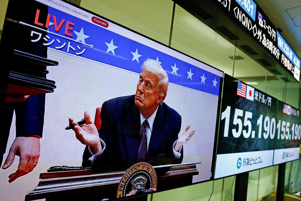 A screen broadcasting live footage shows US President Donald Trump gesturing while signing executive orders next to screens displaying the current Japanese yen exchange rate against the US dollar at a foreign exchange trading company in Tokyo, Japan, on January 21. Photo: Reuters