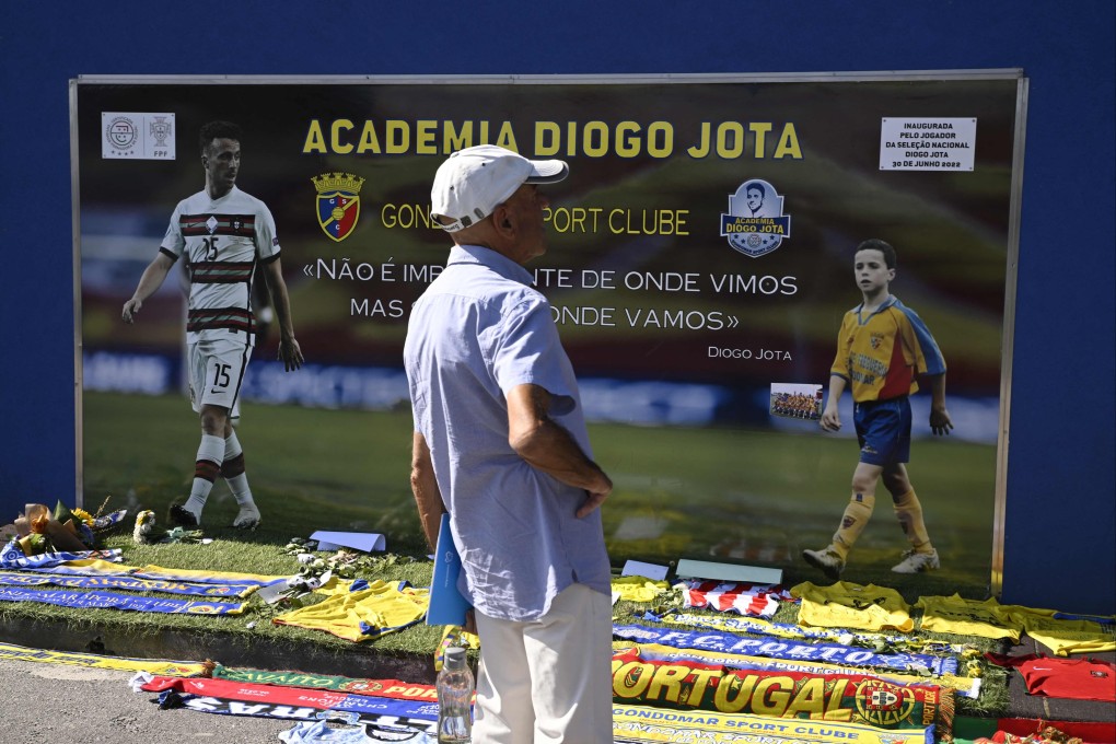 A man stands in front of a memorial on Friday for Liverpool’s Portuguese forward Diogo Jota, set up at the Gondomar Sport Clube’s stadium, where the late footballer began his career, in Gondomar, on the outskirts of Porto. Photo: AFP