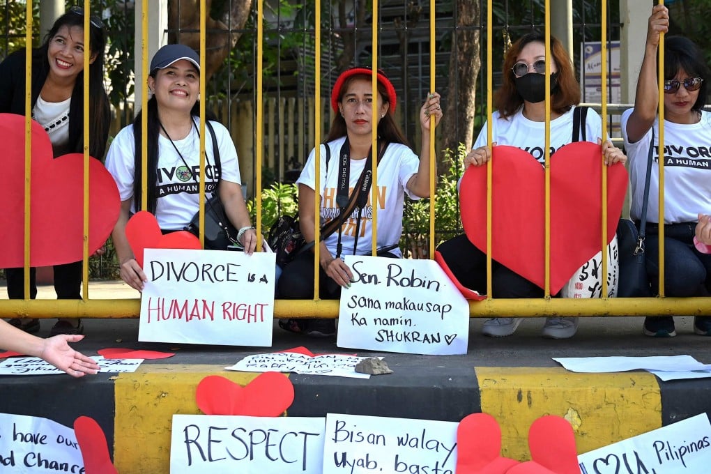 Pro-divorce protesters take part in a demonstration in front of the Senate Building in Pasay, Metro Manila. Photo: AFP