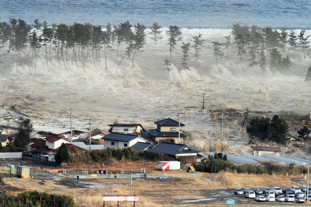 Massive tsunami waves triggered by a major earthquake in northeastern Japan engulf houses in Natori, Miyagi prefecture, on March 11, 2011. Photo: Kyodo