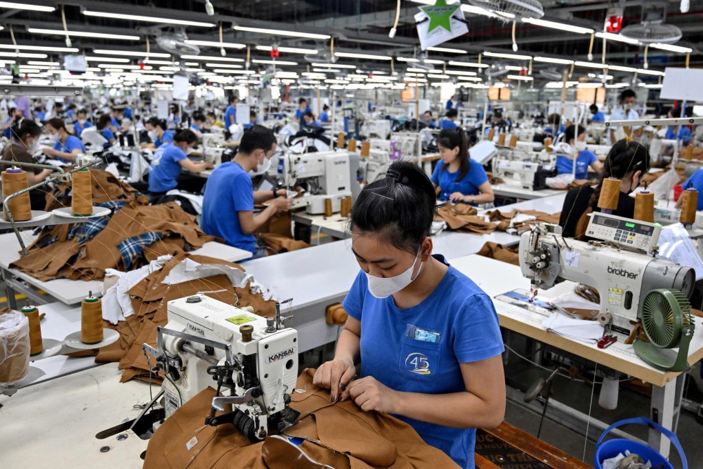 A worker stitches clothes at a garment factory in Vietnam. Vietnam has agreed a trade deal with the United States, which will lower US tariffs on the country’s goods to 20 per cent. Photo: AFP