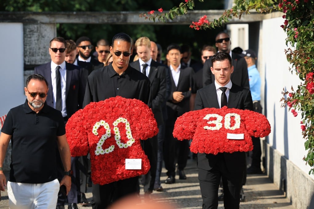 Liverpool players Virgil van Dijk (left) and Andrew Robertson carry floral tributes for the late Portuguese player Diogo Jota and his brother, Andre Silva, in Gondomar, Portugal on Saturday. Photo: EPA