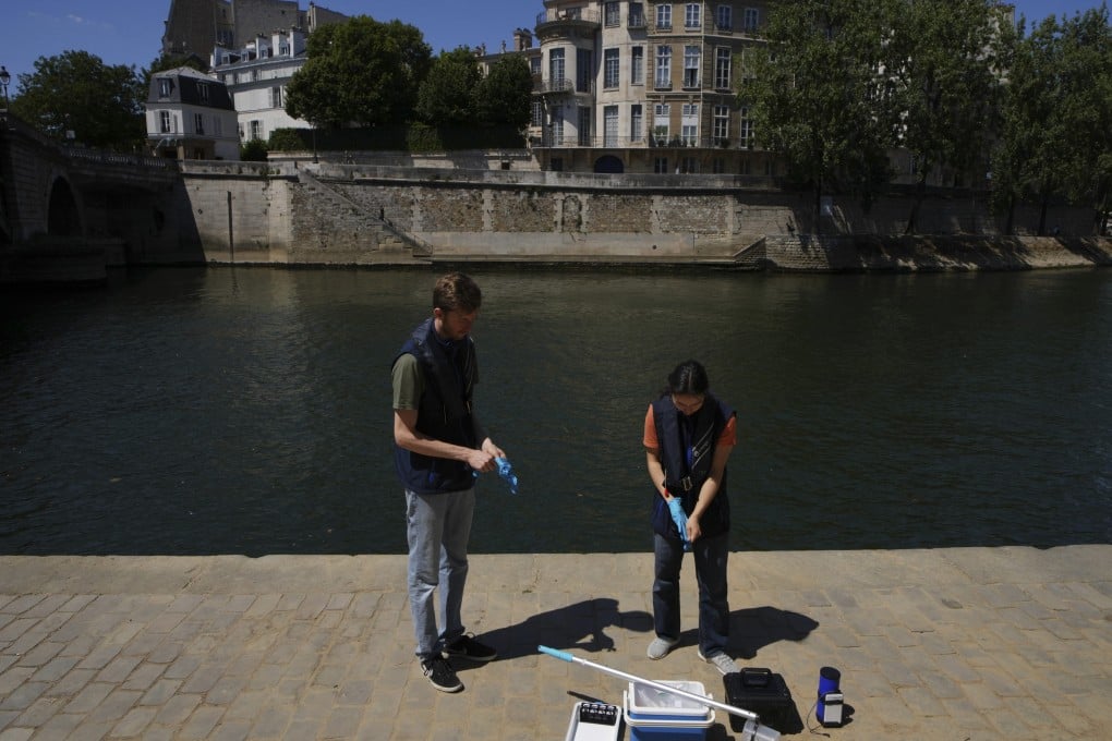 Fluidion workers test the Seine river water quality on Thursday, ahead of the opening of the three Seine swimming pools from Saturday to August 31 in Paris. Photo: AP