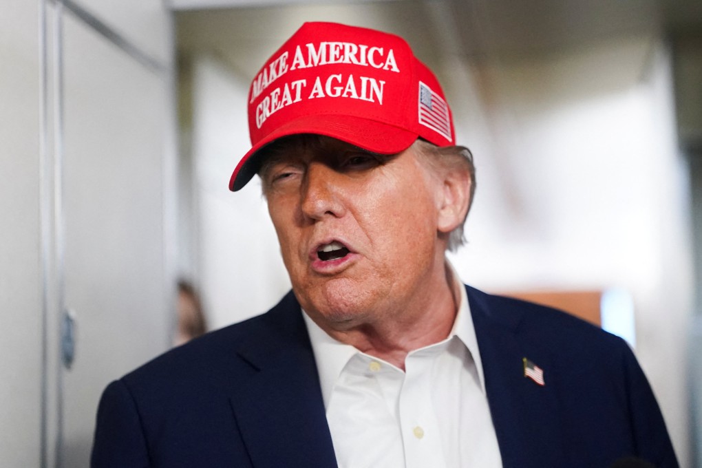 US President Donald Trump speaks to members of the media on board Air Force One on the way to New Jersey on Friday. Photo: Reuters