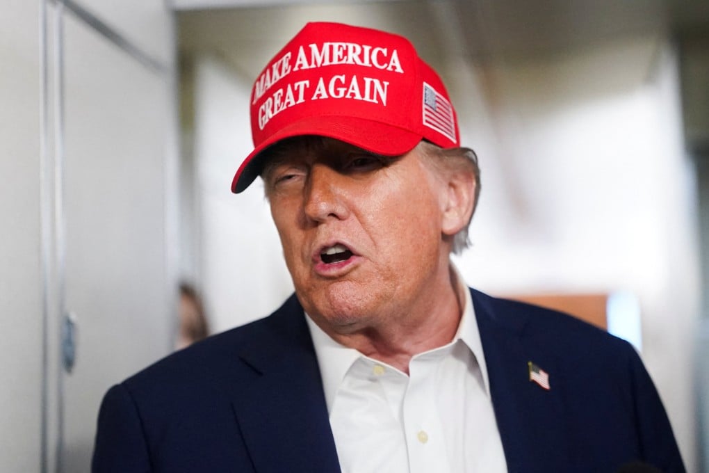 US President Donald Trump speaks to members of the media on board Air Force One on the way to New Jersey on Friday. Photo: Reuters