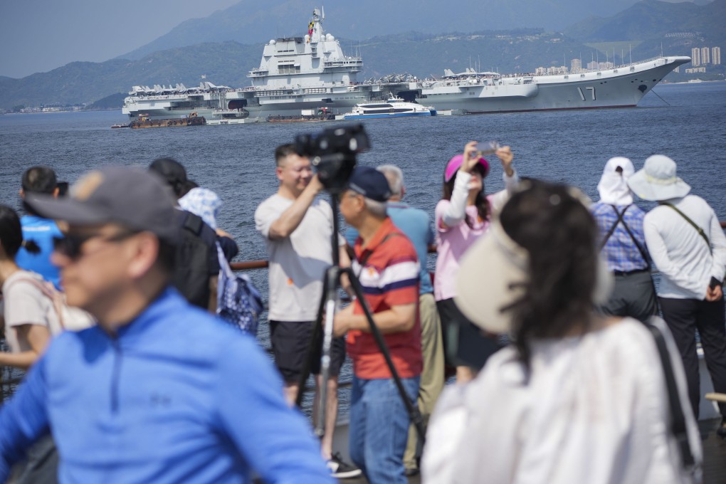 Sightseers gather to get a glimpse of the Shandong. Photo: May Tse