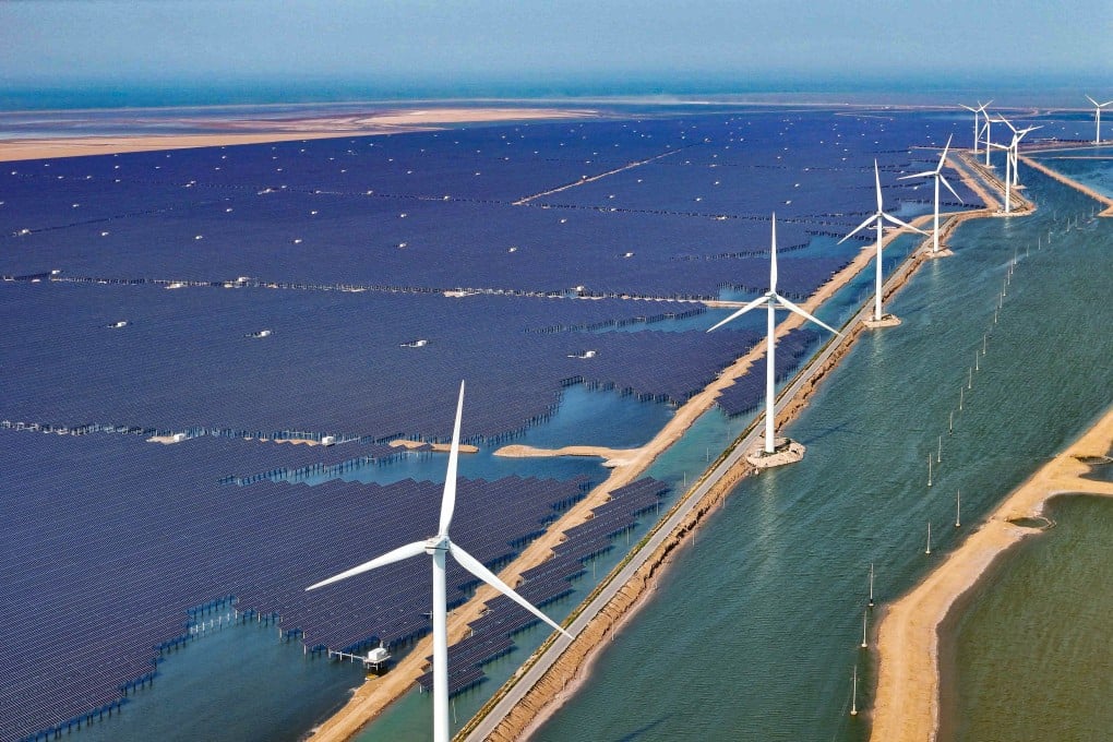 Solar panels and wind turbines are seen at a new energy power generation project in the city of Binzhou in China’s Shandong province on June 11. Photo: AFP