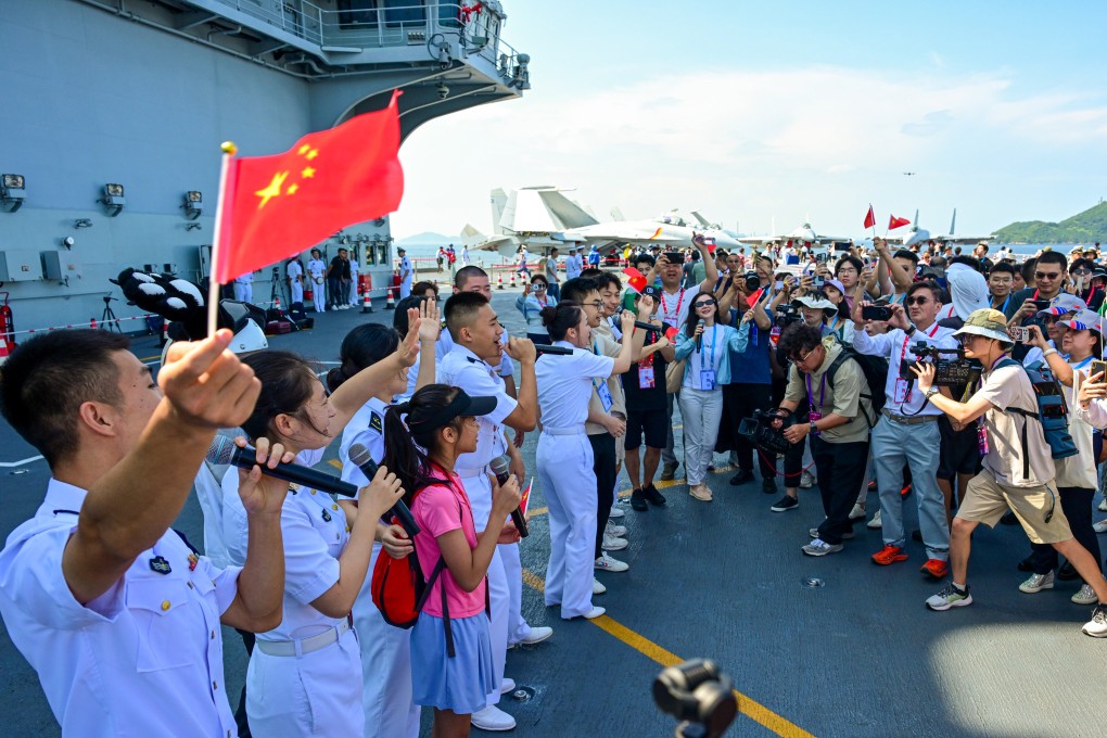 Crew members perform for visitors on the deck of the aircraft carrier Shandong in Hong Kong. Photo: Xinhua