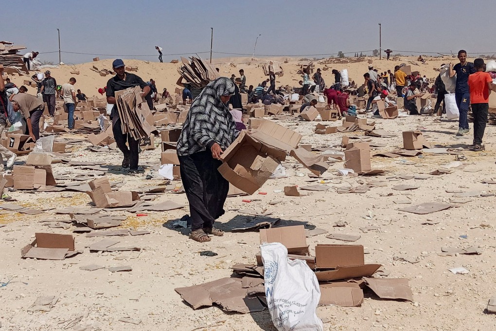 Palestinians gather to collect what remains of relief supplies from the Gaza Humanitarian Foundation, distribution centre in Rafah on Saturday. Photo: Reuters