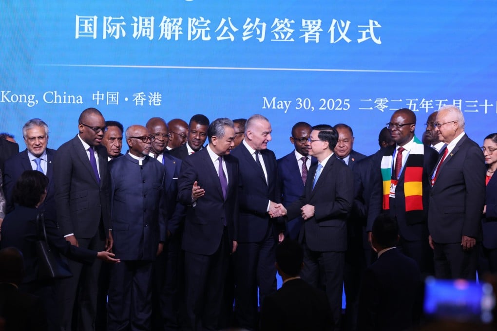 Chinese Foreign Minister Wang Yi (centre left) and Hong Kong Chief Executive John Lee (centre right) attend the signing ceremony for the convention on the establishment of the International Organisation for Mediation in Hong Kong on May 30. Photo: Nora Tam