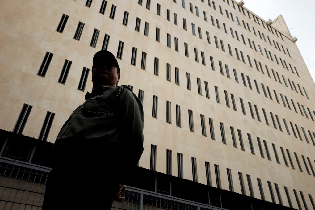 A Correctional Services Department officer stands in front of Lai Chi Kok Reception Centre, a maximum security prison in Kowloon. Photo: Reuters