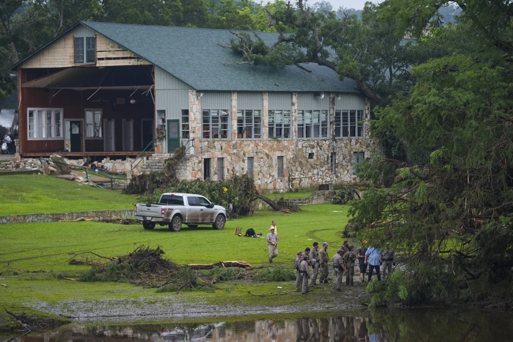 Officials search on the grounds of Camp Mystic along the banks of the Guadalupe River on Sunday after a flash flood swept through the area. Photo: AP