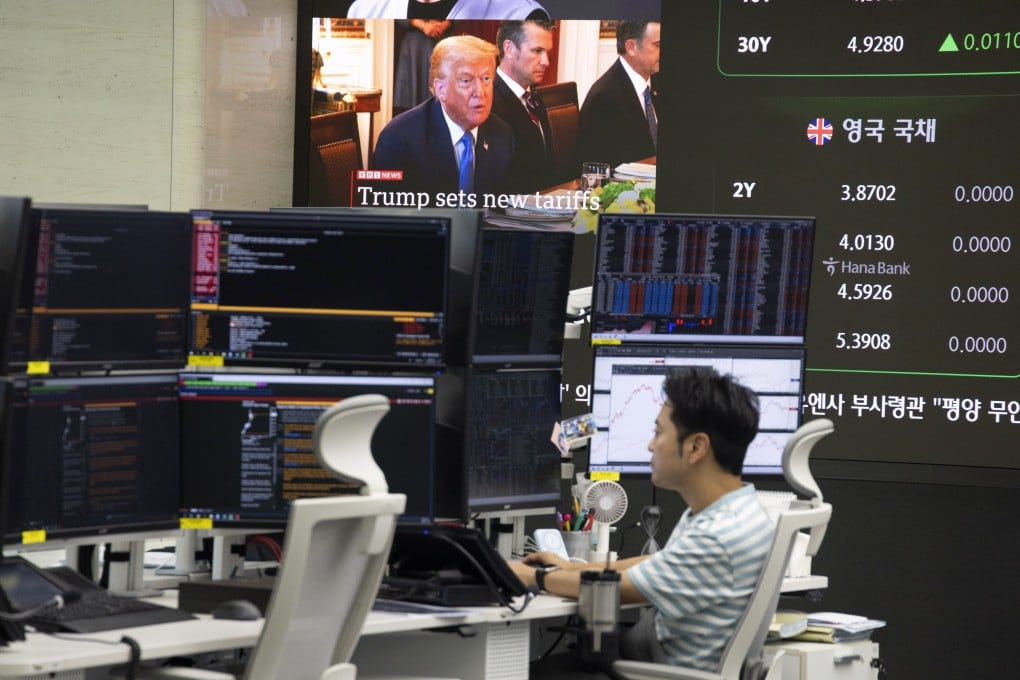 A South Korean dealer works in front of monitors at the Hana Bank in Seoul, South Korea, on Tuesday. US President Donald Trump confirmed plans to impose a 25 per cent tariff on Japan and South Korea. Photo: EPA