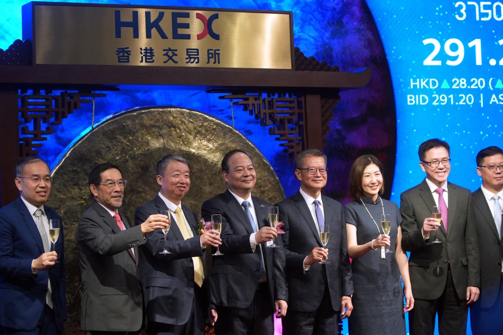 Financial Secretary Paul Chan Mo-po (fourth from right) and Bonnie Chan Yiting (third from right), CEO of the Hong Kong stock exchange, celebrate the listing of Contemporary Amperex Technology (CATL), a Chinese battery company that joined the market ahead of the launch of the new Technology Enterprises Channel that is aimed at attracting more firms from the tech sector. Photo: SCMP