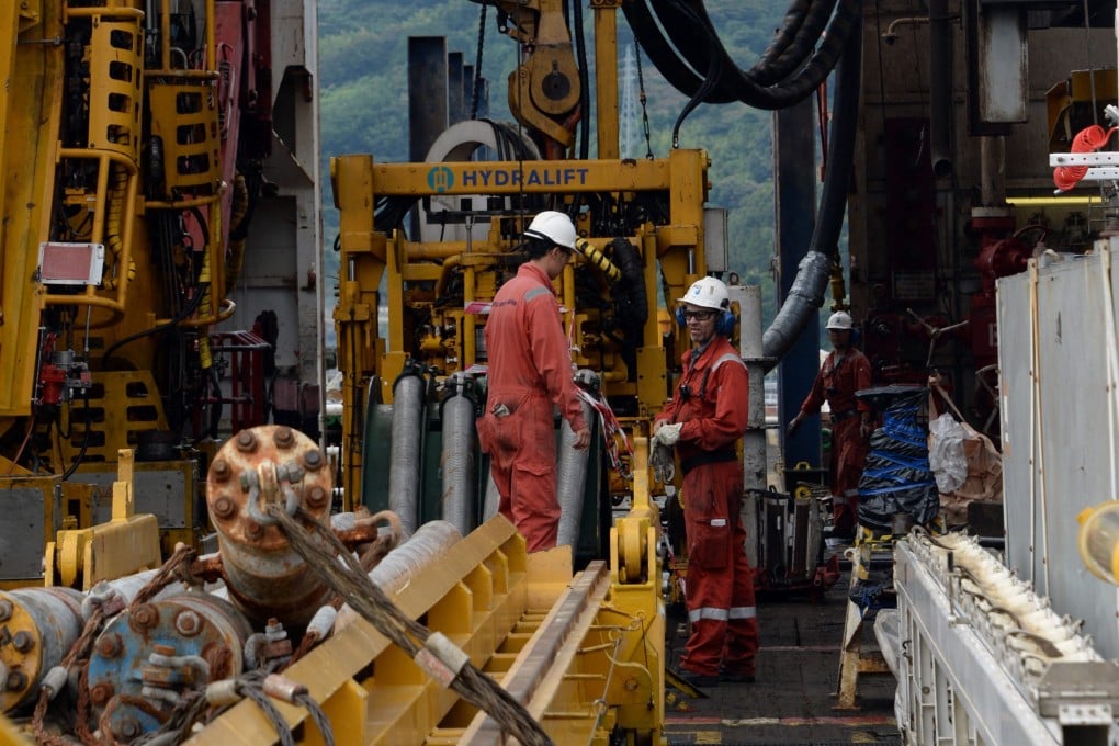 Workers check drilling machines on board the Japanese deep-sea drilling vessel Chikyu. Japan’s plans call for the ship to extract roughly 35 tonnes of seabed mud over a three-week period. Photo: AFP