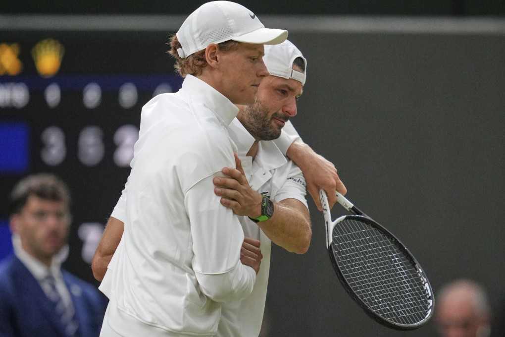 Jannik Sinner (left) helps a tearful Grigor Dimitrov off the court at Wimbledon. Photo: AP