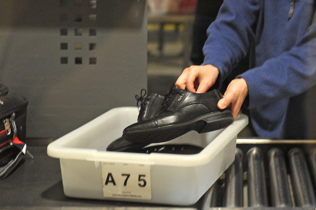 A traveller places his shoes in a bin before passing through the TSA security check at Los Angeles International Airport. File photo: TNS