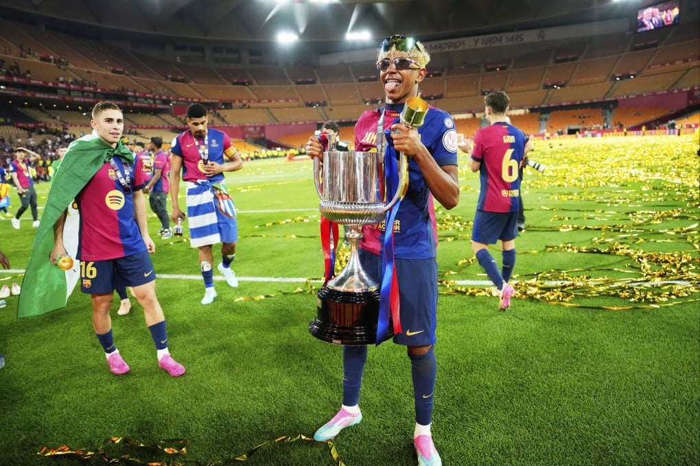 Barcelona’s Lamine Yamal holds the Spanish Cup trophy following victory over Real Madrid in April. Photo: AP