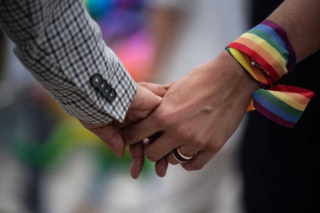 An LGBTQ couple holds hands during an event to raise awareness of gay rights in Hong Kong. Photo: AFP