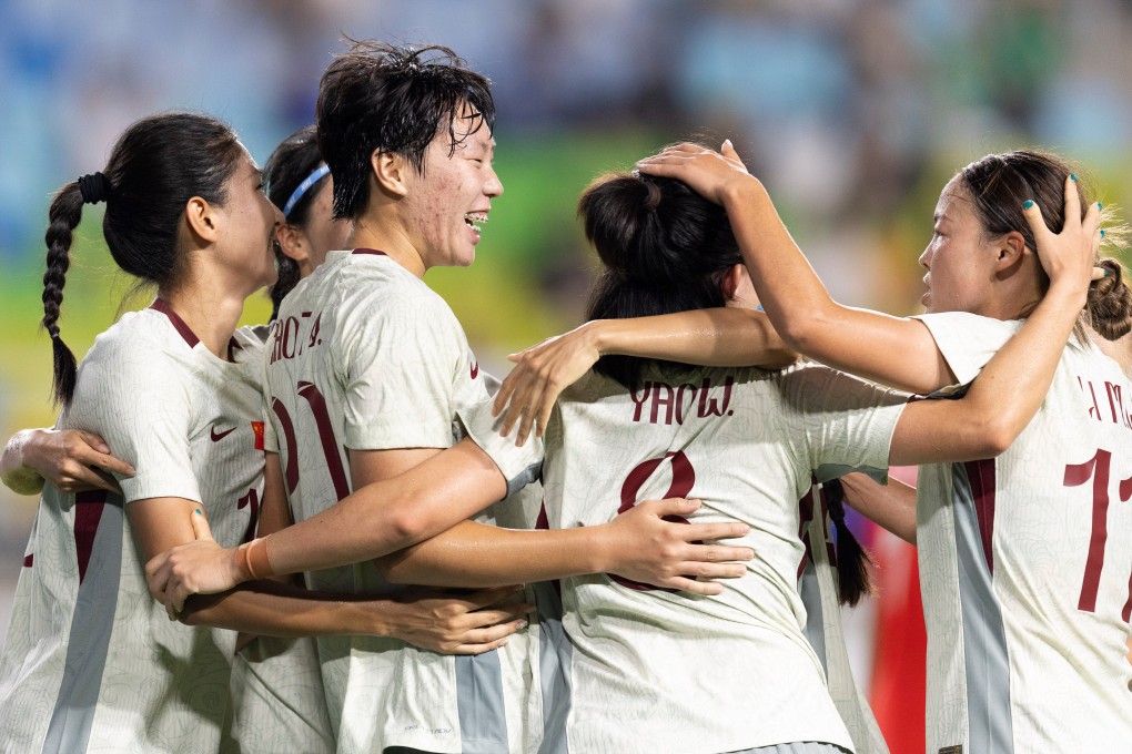 Shao Ziqin (second from left) is mobbed after putting China 2-1 in front against South Korea. Photo: Xinhua
