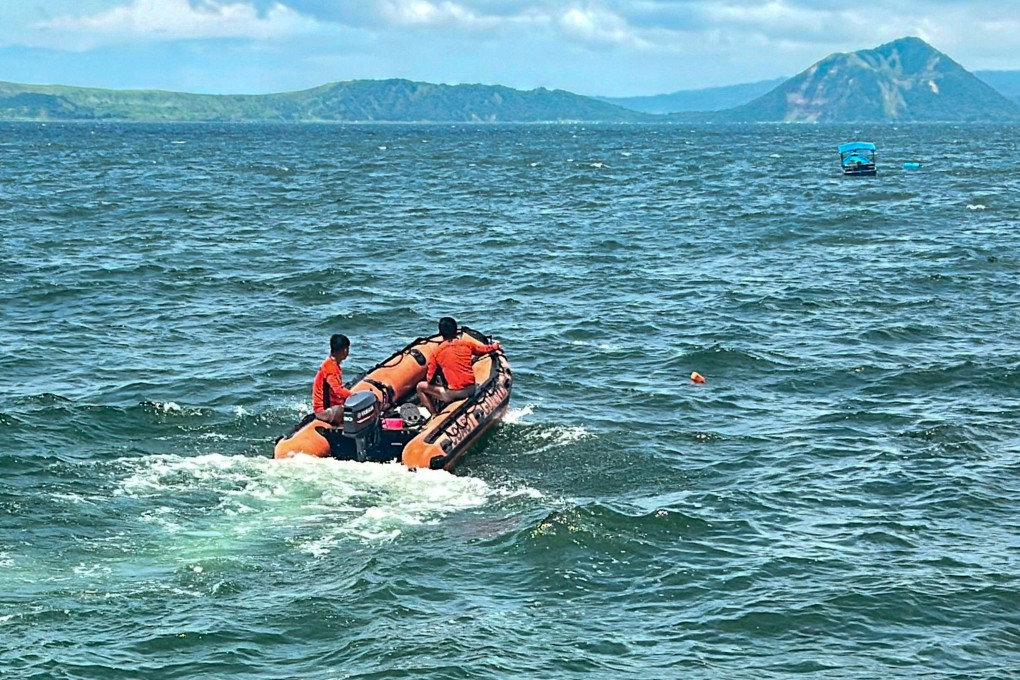 Philippine Coast Guard personnel scour Talisay waters on Thursday as divers prepare to search Lake Taal, where authorities hope to locate the bodies of missing cock fighters allegedly dumped in the area. Photo: Handout