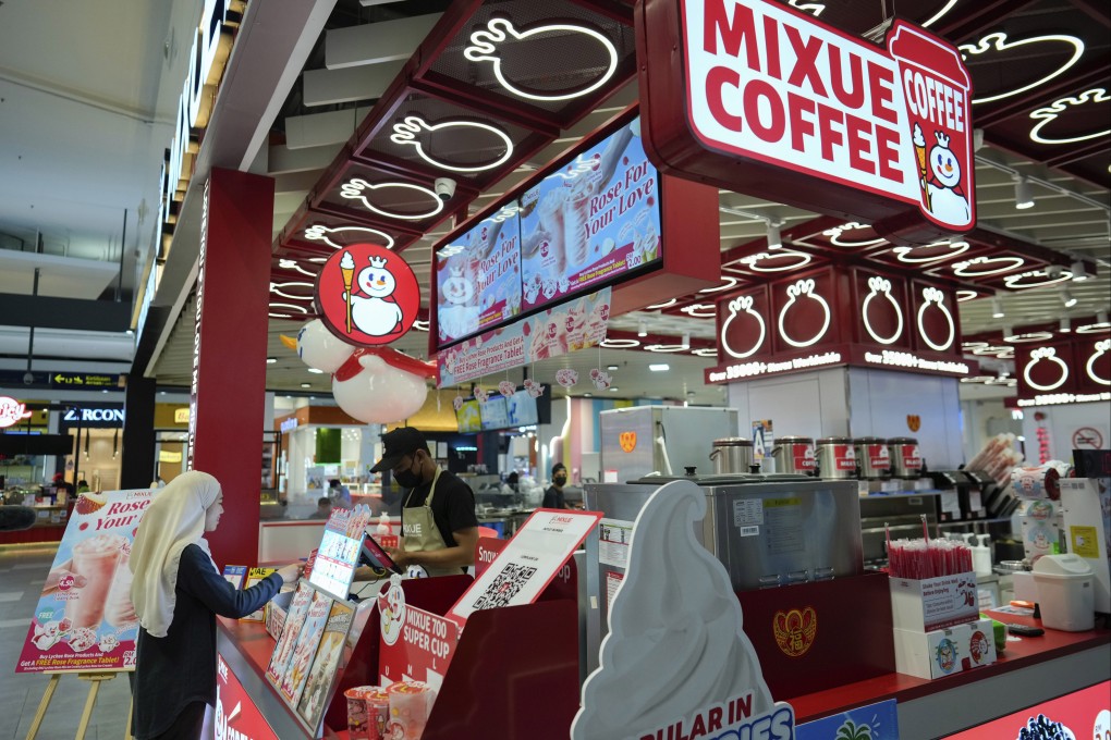 A woman buys a drink from Mixue outlet at a shopping centre in Sepang, Malaysia. Photo: AP