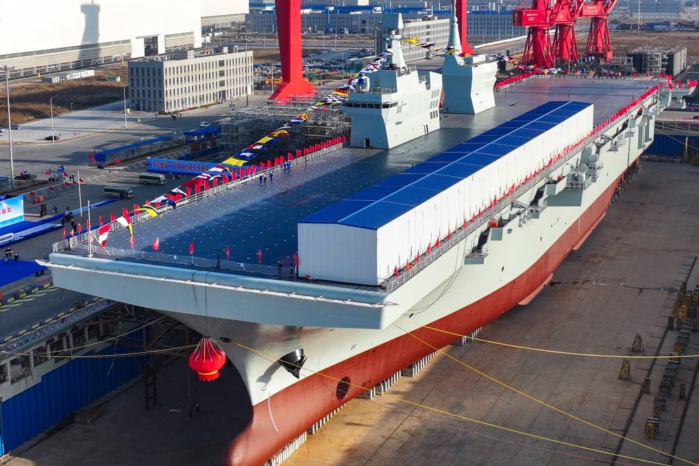 China’s first Type 076 new-generation amphibious assault ship, the Sichuan, is seen in a Shanghai shipyard last December. The flat-top vessel will serve as a fleet command centre that will enable drones, helicopters, fighters and landing craft to approach an adversary’s coast. Photo: Xinhua