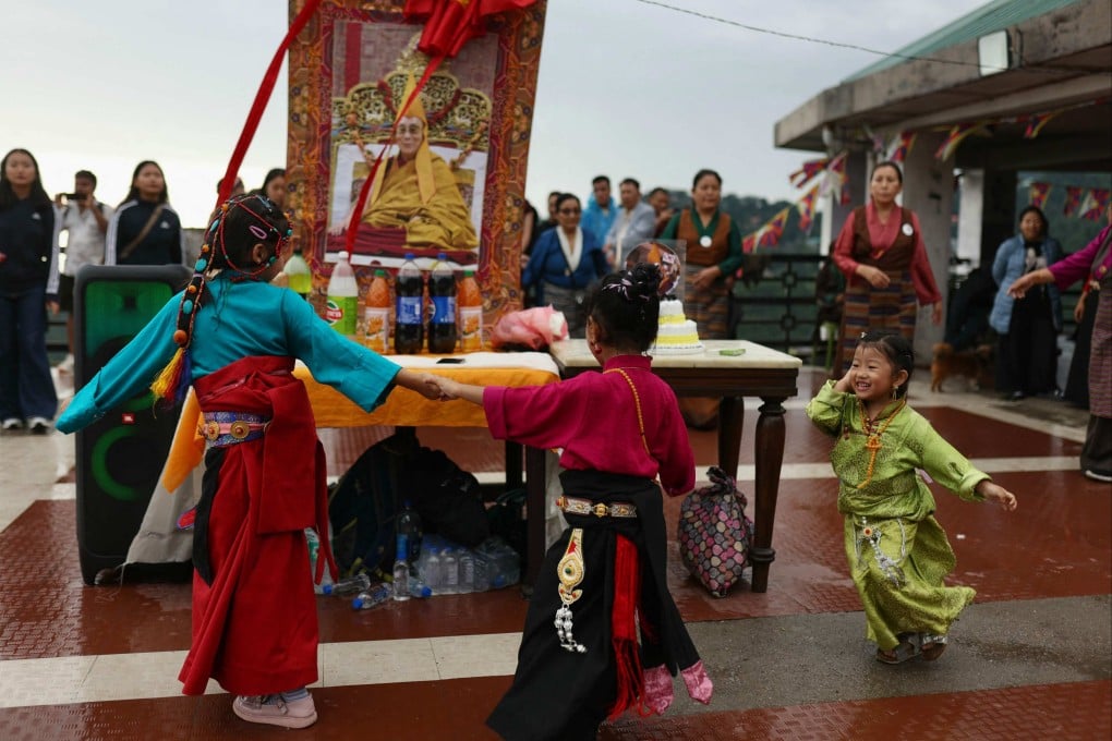 Children take part in a Tibetan circle dance around a portrait of the Dalai Lama on his 90th birthday, in McLeod Ganj near Dharamsala, India, on Sunday. India has hosted the Dalai Lama and the Tibetan government-in-exile in Dharamsala since 1959. Photo: AFP