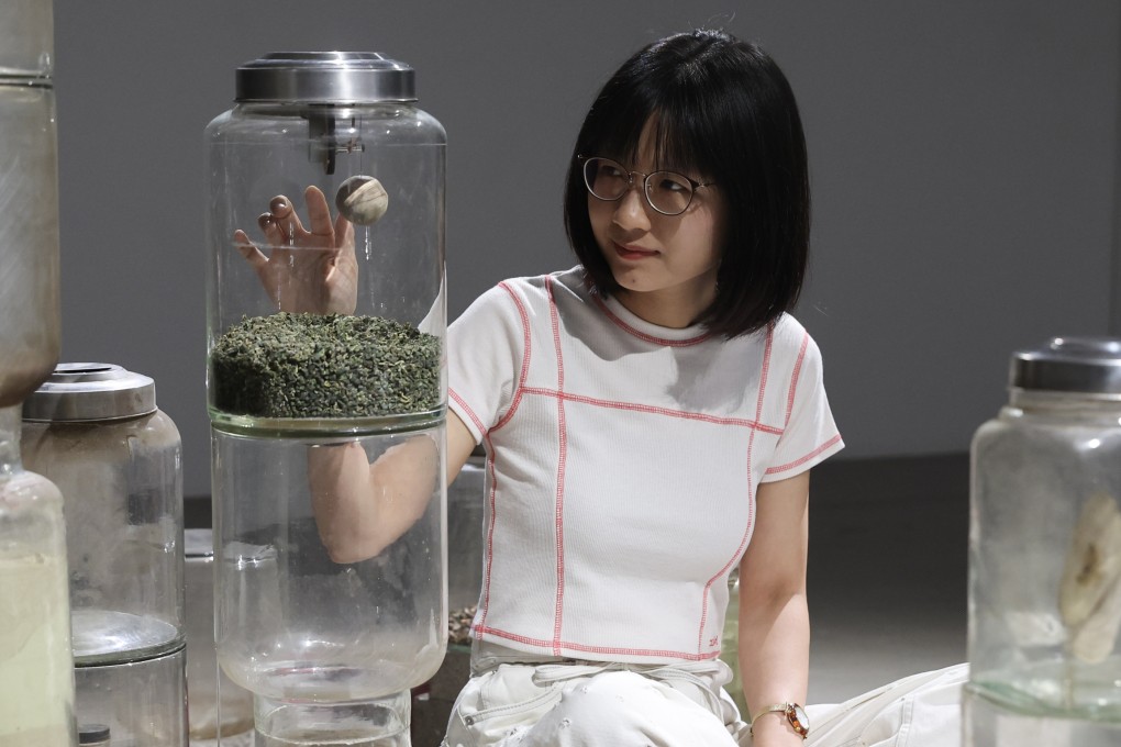Hong Kong artist So Wing-po sits with her artwork Polyglot: Mulberry (2023) at her solo exhibition at Blindspot Gallery in Wong Chuk Hang, Hong Kong, on June 28, 2025. Photo: Edmond So