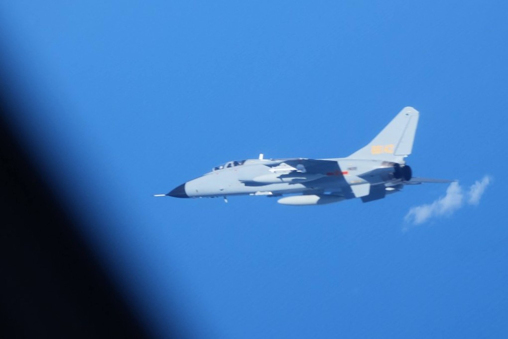 A Chinese JH-7 fighter-bomber flying close to a Japan Air Self-Defence Force YS-11EB intelligence-gathering aircraft on surveillance over the high seas in the East China Sea on July 9. Photo: Japan’s Ministry of Defence / AFP